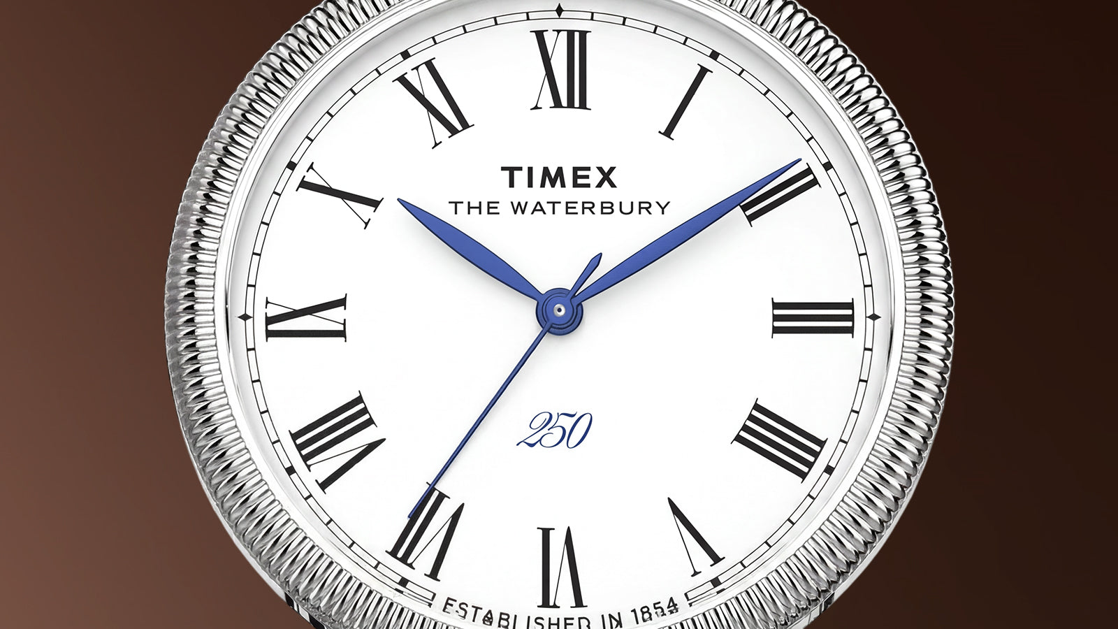 Detailed view of the Waterbury America 250 Table Clock dial with Roman numerals, blue hands, and commemorative America 250 marking.