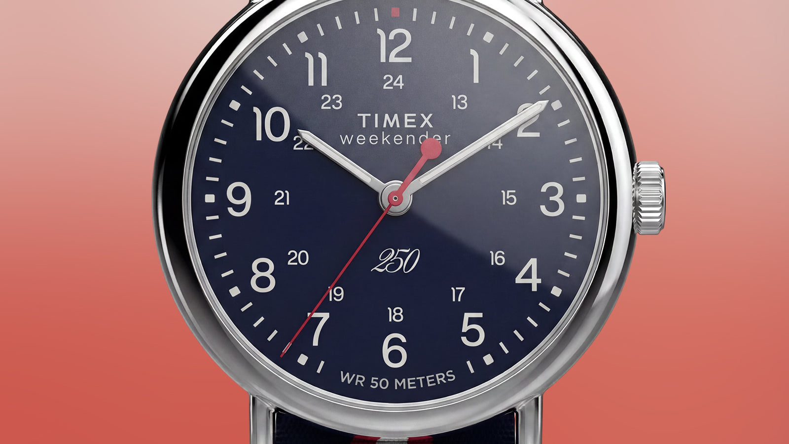 Close-up of the Weekender America 250 dial highlighting white numerals, 24-hour markings, red seconds hand, and commemorative America 250 logo.