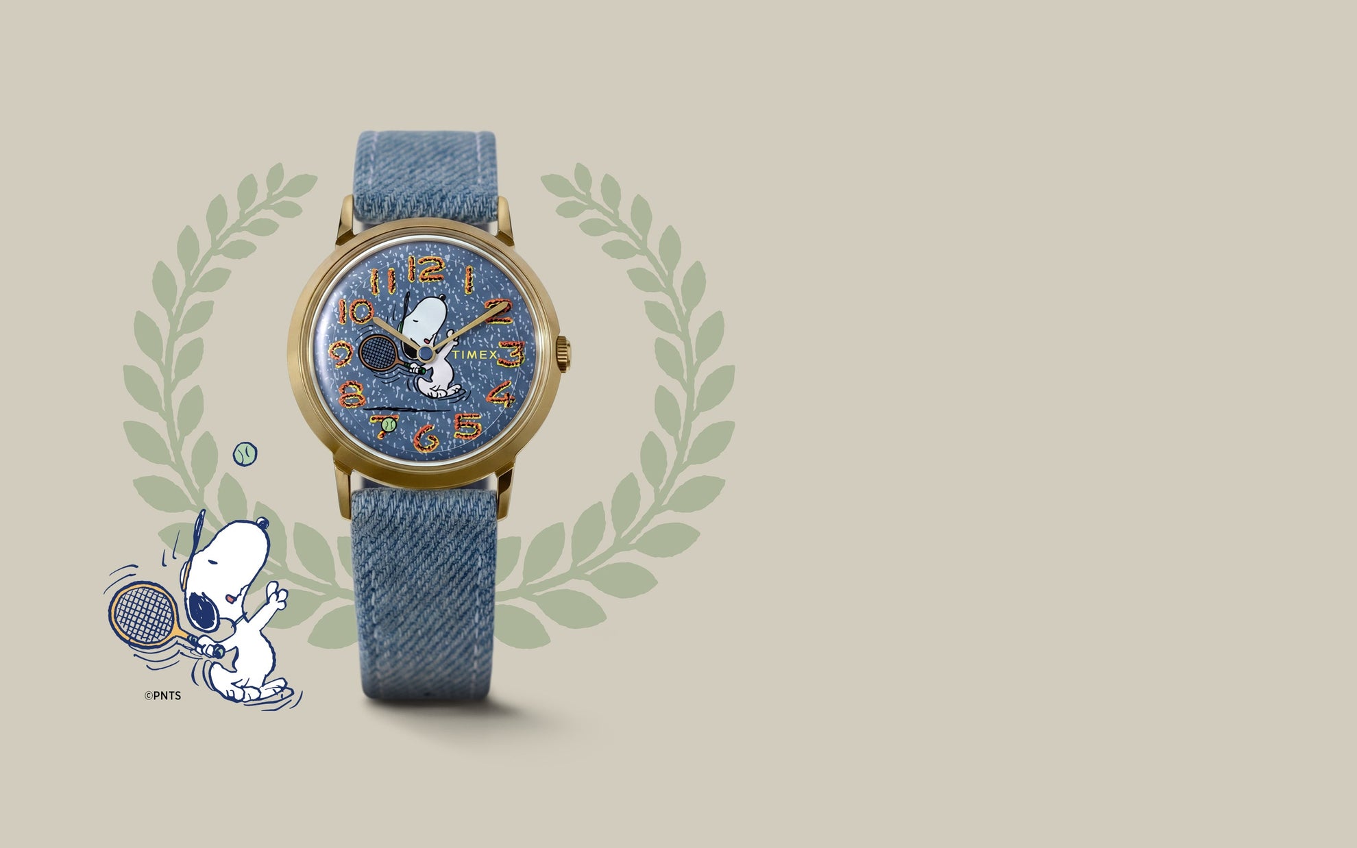 Peanuts® x Timex Marlin® 1965 Reissue Inspired Snoopy Tennis watch featuring a gold-tone case, blue denim-style strap, and Snoopy tennis artwork on the dial.