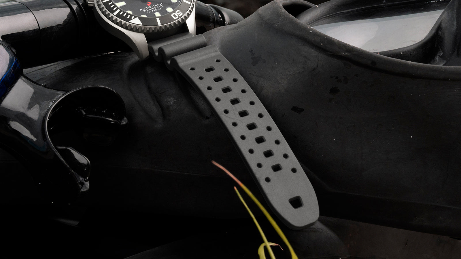 Black rubber strap of the Timex Deepwater Meridian 300 Titanium HEV Automatic displayed on scuba diving equipment.