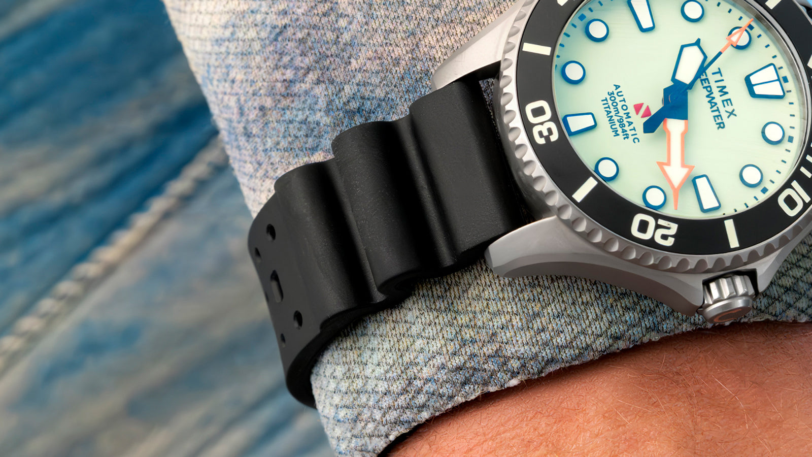 Close-up of the black rubber strap and titanium case of the Timex Deepwater Meridian 300 Titanium HEV Automatic worn on the wrist.