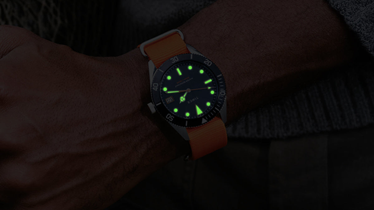 Bespoke Post x Timex Heritage 66 watch featuring luminous green hands and hour markers in the dark.
