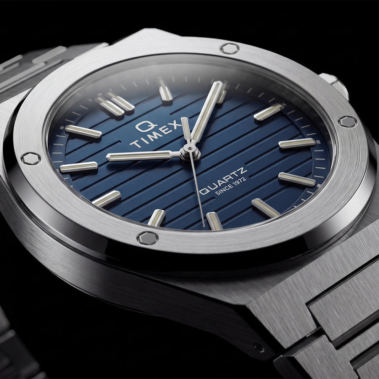 Close-up of the Timex Q Marbella blue textured dial with a brushed stainless steel bezel and integrated bracelet.