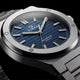 Close-up of the Timex Q Marbella blue textured dial with a brushed stainless steel bezel and integrated bracelet.