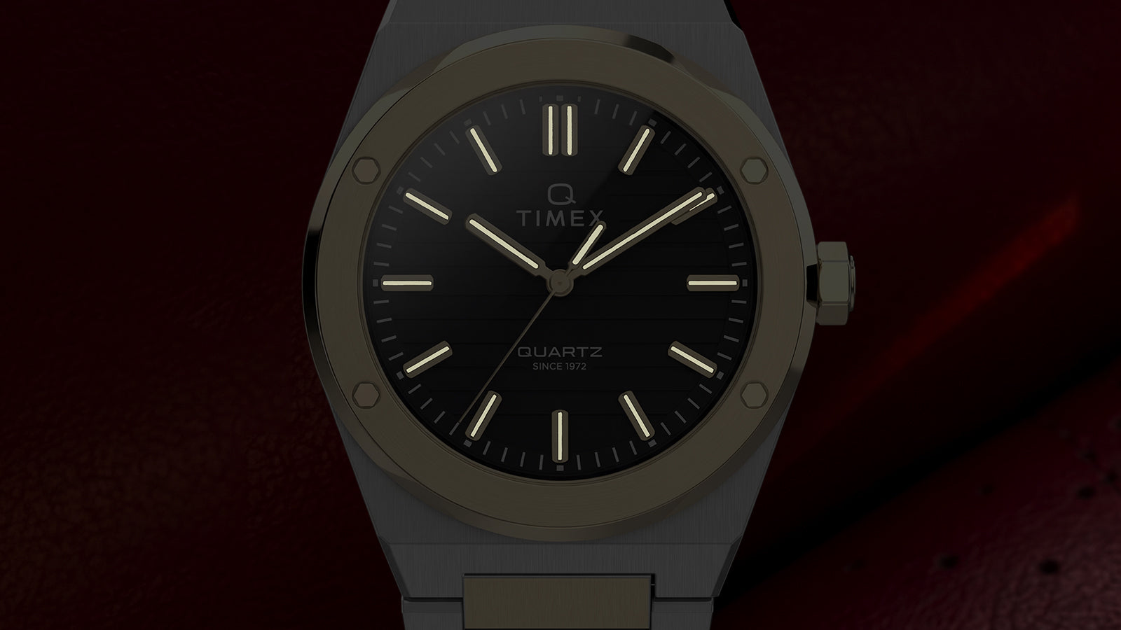 Front view of the Timex Q Marbella watch highlighting glowing hands and hour markers against a dark background.