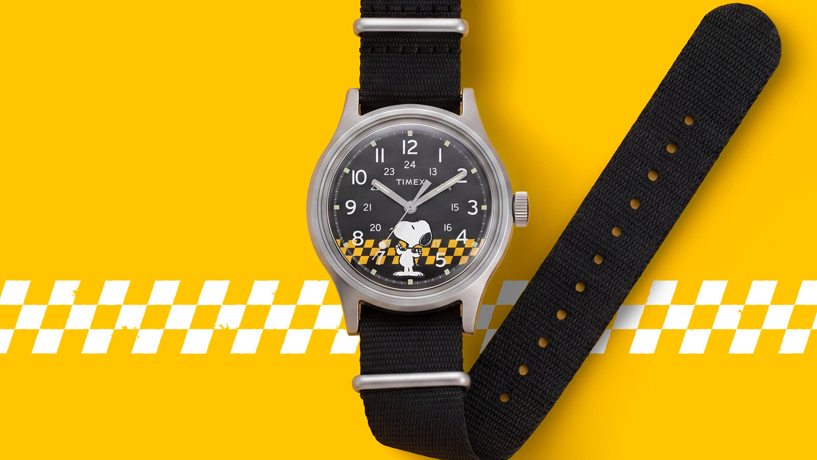 Front view of the Peanuts® x Timex MK1® featuring a black dial with Snoopy artwork, silver-tone case, and black fabric strap.
