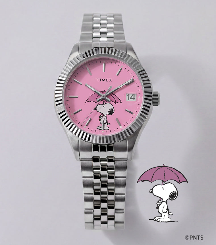 Peanuts® x Timex Legacy Snoopy Umbrella watch with a pink dial, stainless steel bracelet, and Snoopy holding a pink umbrella beside the watch.