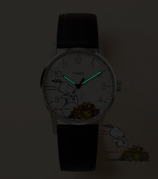Peanuts® x Timex Waterbury Classic watch with INDIGLO® illumination highlighting the glowing hour and minute hands.