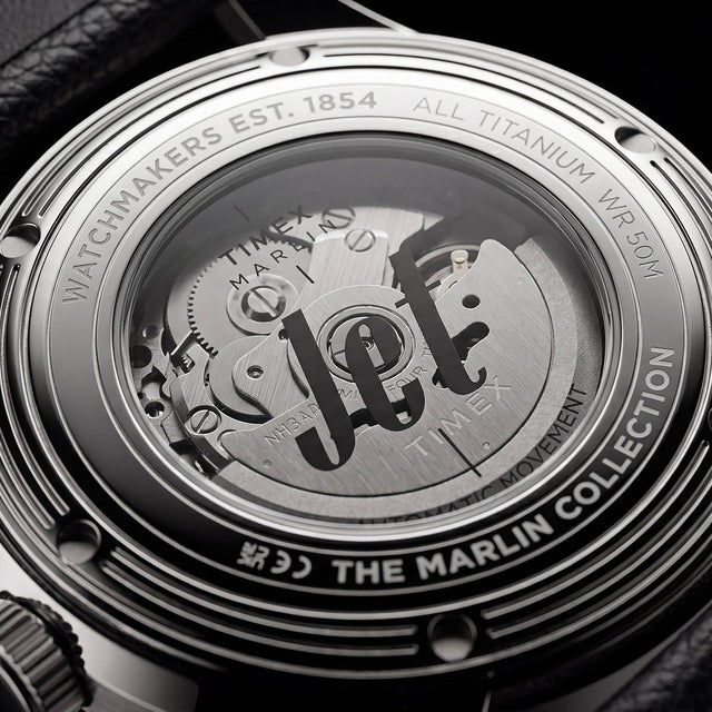 Exhibition caseback of the Timex Marlin® Jet Titanium Automatic GMT showing the automatic movement and custom Timex rotor through a transparent crystal caseback.