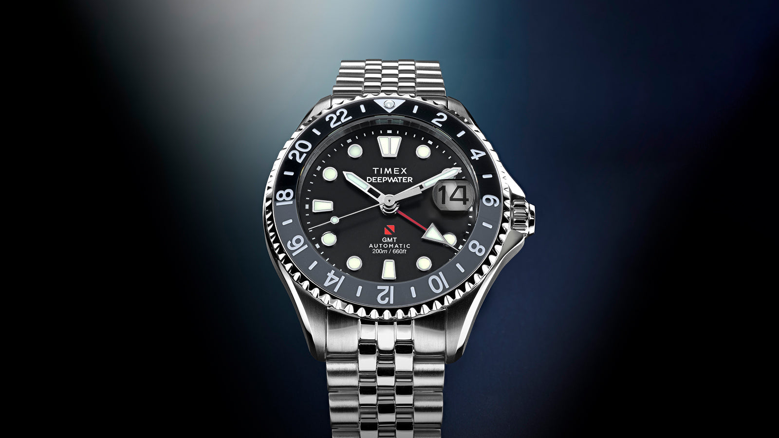 Front-facing view of the Timex Deepwater Meridian 200 Automatic GMT featuring a black dial, stainless steel bracelet, date magnifier, and bi-directional GMT bezel.