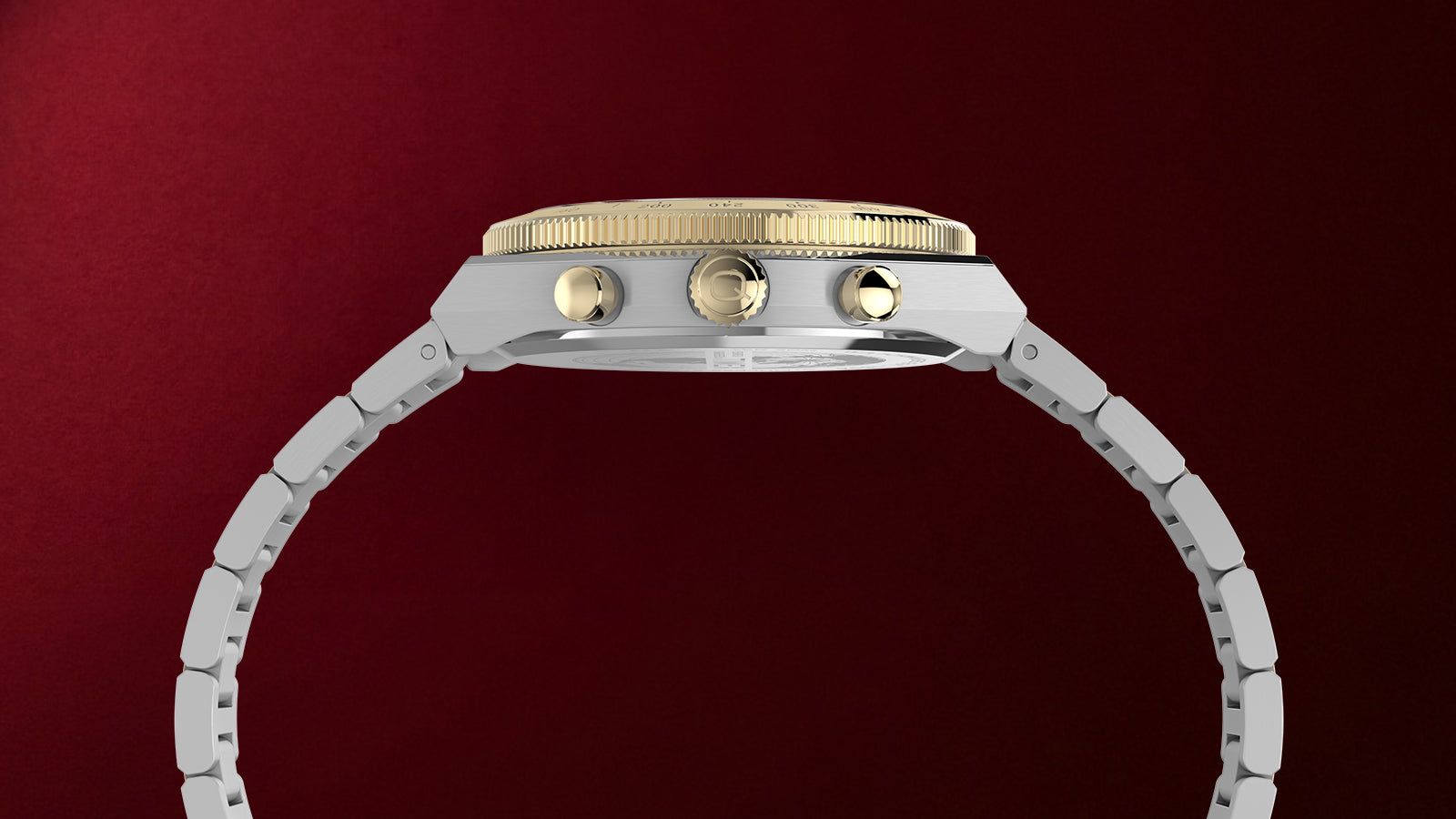 Side view of the Q Timex Continental Chronograph showing its brushed silver-tone case, gold-tone crown and pushers, and two-tone bracelet.