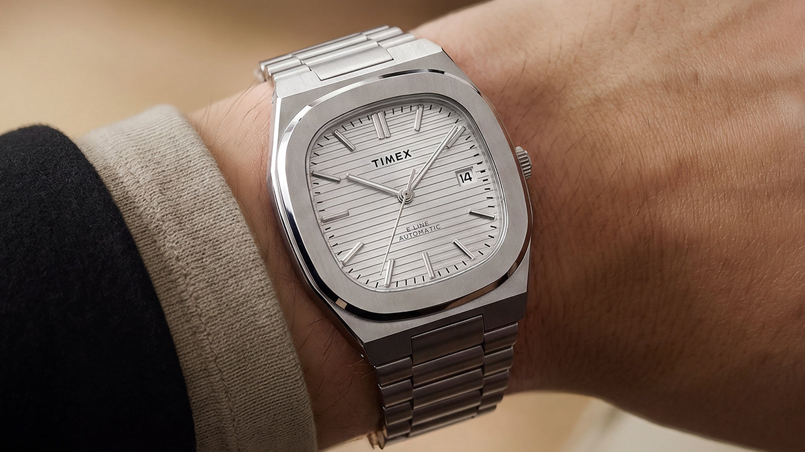 Timex® Automatic E Line 38mm stainless steel watch with a silver textured dial worn on the wrist.