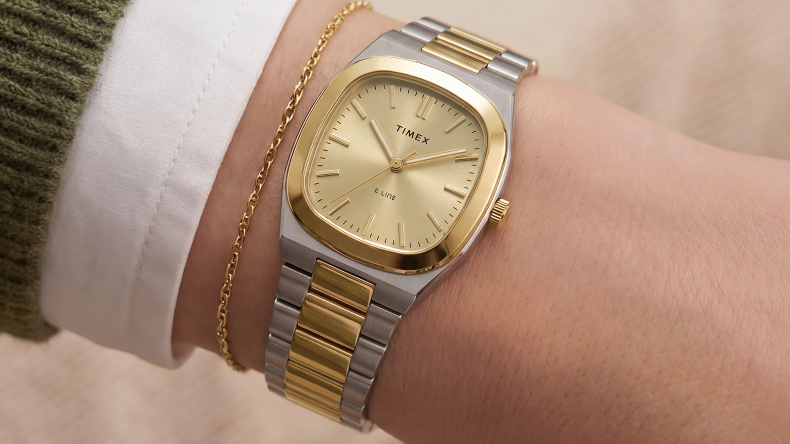 Timex® Quartz E Line 30mm two-tone stainless steel watch with a champagne dial worn on the wrist.