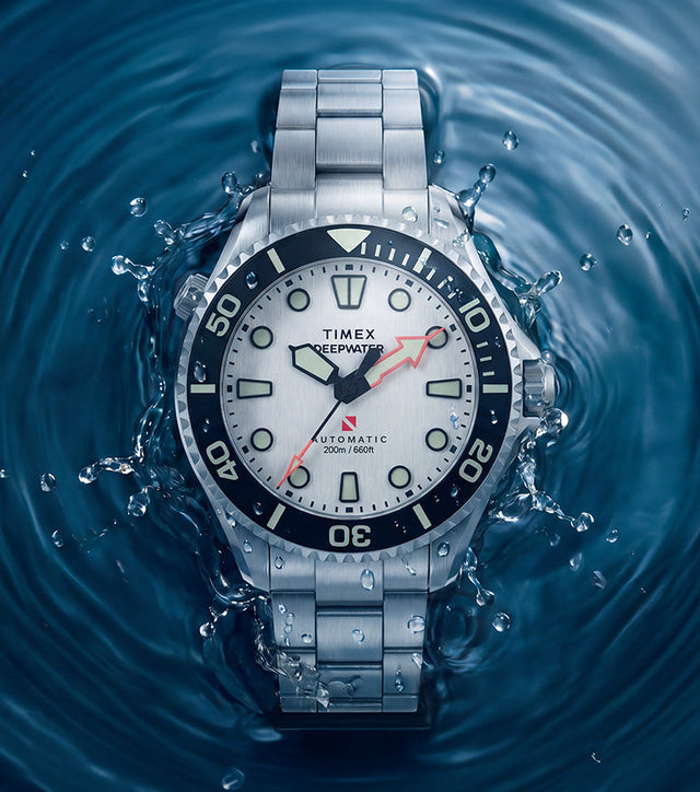 Deepwater Meridian 200 HEV Automatic with a silver-tone dial and stainless-steel bracelet surrounded by splashing blue water.