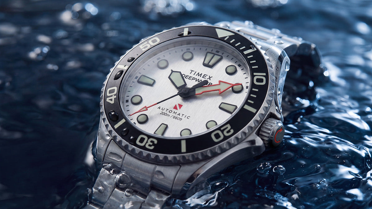 Angled close-up of the Deepwater Meridian 200 HEV Automatic resting in water with droplets across its stainless-steel case.