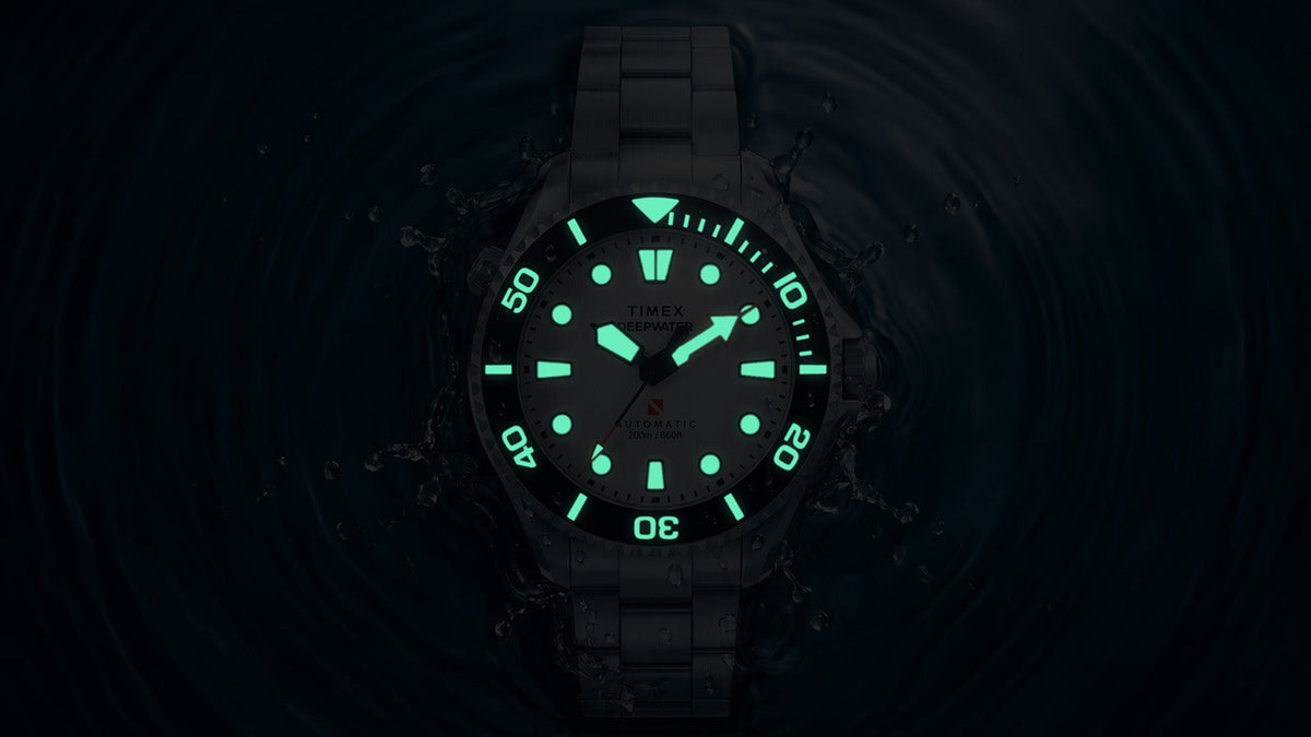 Deepwater Meridian 200 HEV Automatic in darkness, highlighting the glowing hands, hour markers, and bezel markings.