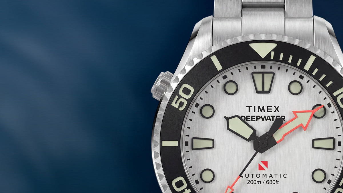 Detailed view of the Deepwater Meridian 200 HEV Automatic’s silver-tone dial, luminous hands, and black rotating bezel.
