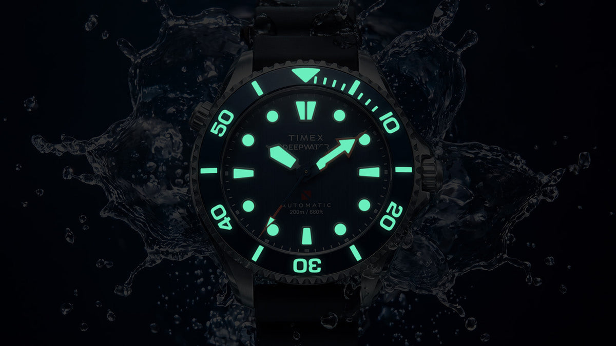 Deepwater Meridian 200 HEV Automatic in darkness with illuminated hands, hour markers, and bezel markings.