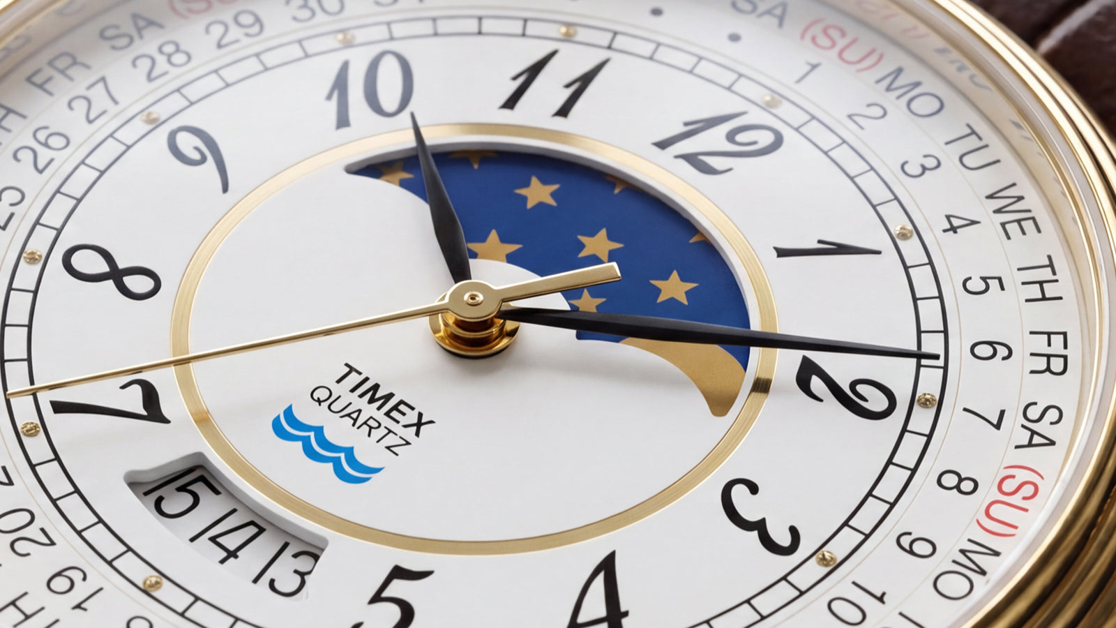 Detailed view of the blue-and-gold moon phase display, black numerals, calendar markings, and gold-tone hands.