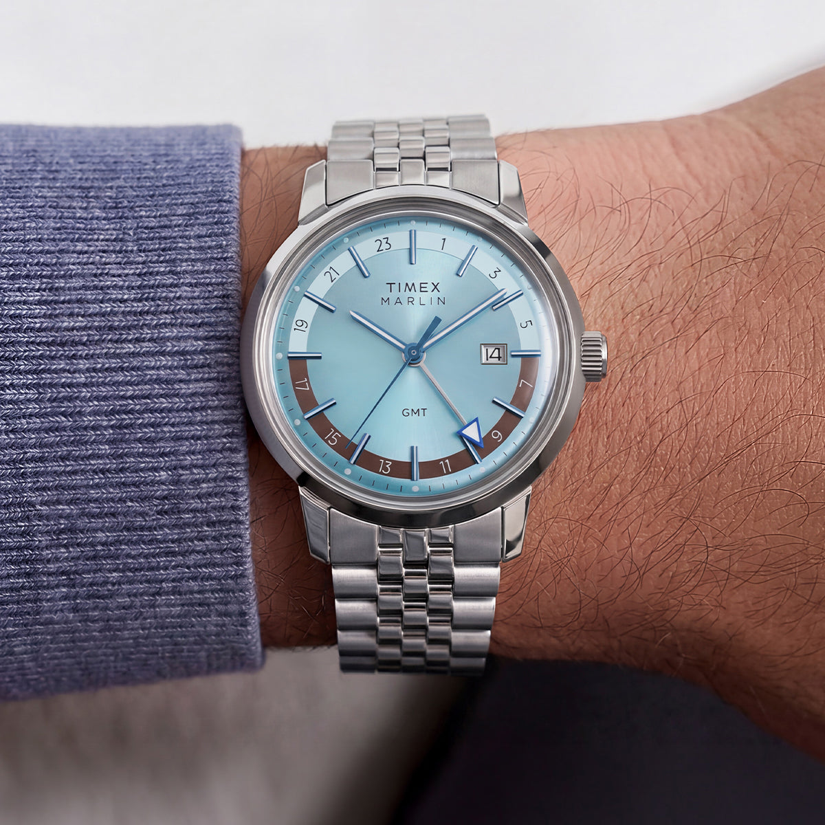 Marlin® Quartz GMT worn on the wrist, showcasing its icy blue dial and stainless-steel bracelet.