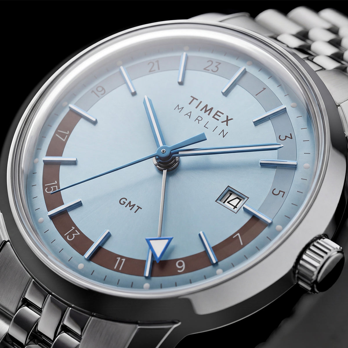 Detailed angled view of the Marlin® Quartz GMT dial, blue hands, GMT hand, and date window.