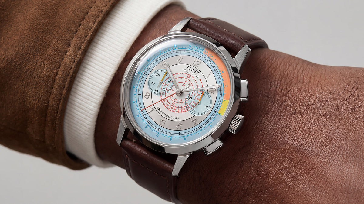 Marlin® Neo Classic Chronograph worn on a wrist with a brown jacket, featuring a multicolor dial and brown leather strap.