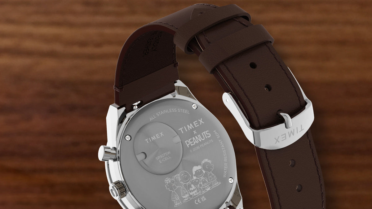 Back view of the Peanuts® x Q Timex Chronograph featuring an engraved Peanuts character design and a brown leather strap.