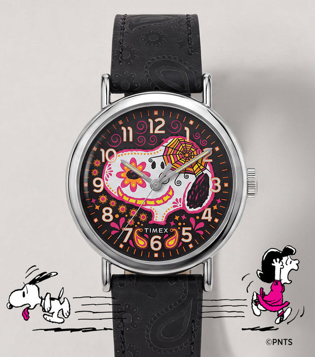 Peanuts® x Timex Weekender® Day of the Dead watch with a black embossed leather strap and colorful Snoopy sugar-skull dial.