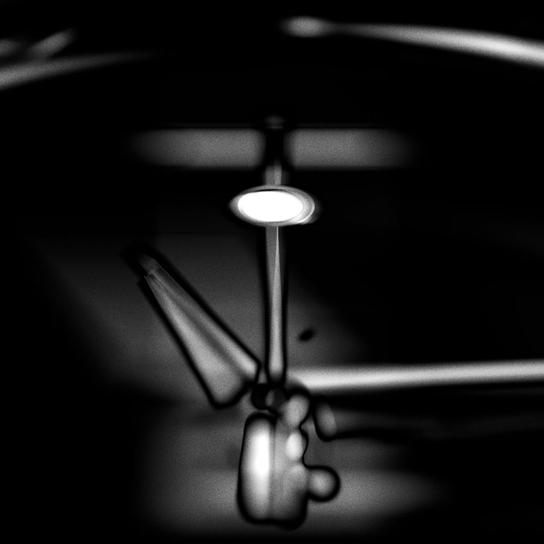 Abstract black-and-white close-up revealing the internal components of a mechanical watch.