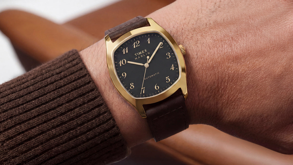 TW2Y84500 Close-up of the Marlin® Chatham Automatic watch on a wrist, showing its gold-tone case and raised Arabic numerals.