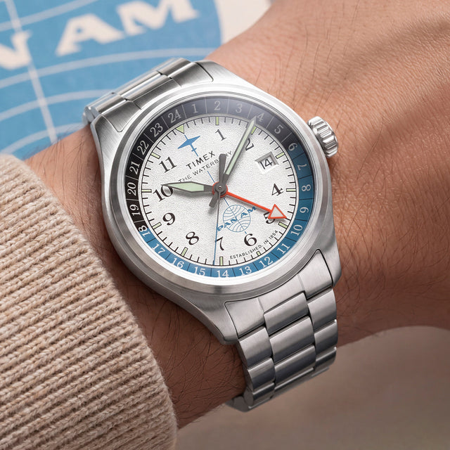 TW2Y94600 Pan Am x Timex Waterbury Automatic GMT watch with a stainless-steel bracelet worn on the wrist.