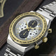 TW2Y75900 Angled close-up of the watch, showing its star-patterned dial, two dark subdials, gold-tone bezel, and metal bracelet.