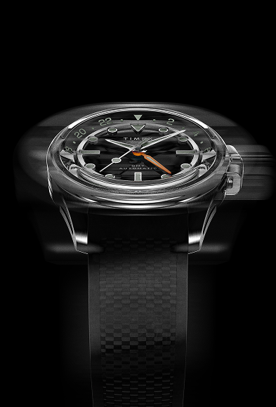 Front motion-blur image of the Timex Atelier GMT Automatic highlighting its polished stainless steel case and dynamic dial design.