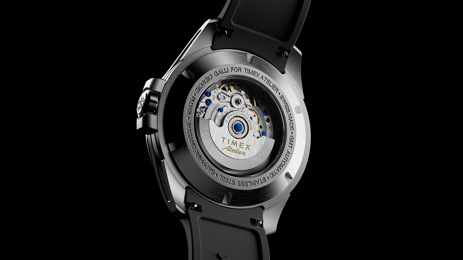 The exhibition caseback of the Timex Atelier GMT Automatic showing the Swiss-made automatic movement with visible rotor engraved “TIMEX Atelier.”