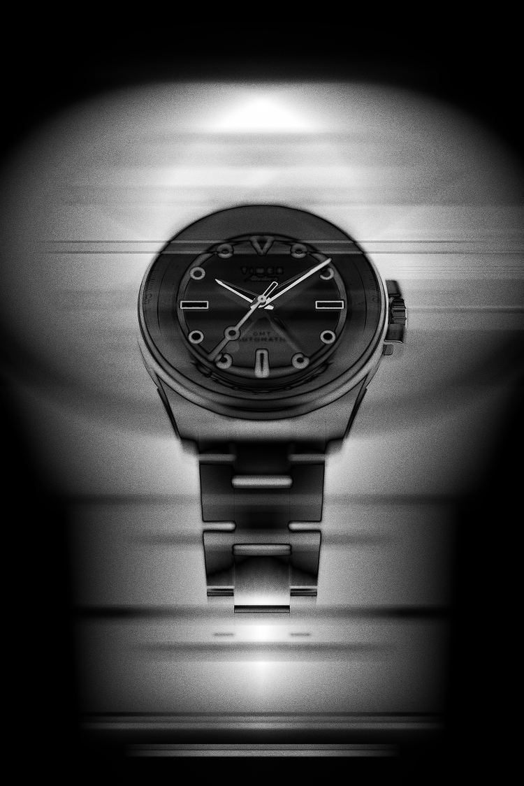 Artistic black-and-white shot of the Timex Atelier GMT Automatic watch viewed head-on with a motion effect emphasizing precision and craftsmanship.