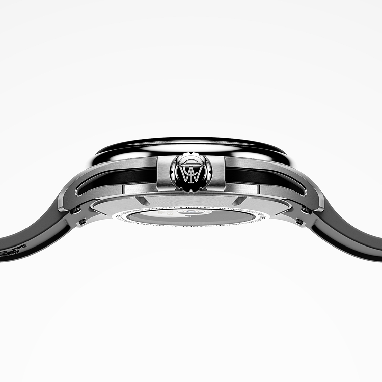 Side profile of the Timex Atelier GMT Automatic highlighting its slim stainless steel case, black accents, and engraved crown.