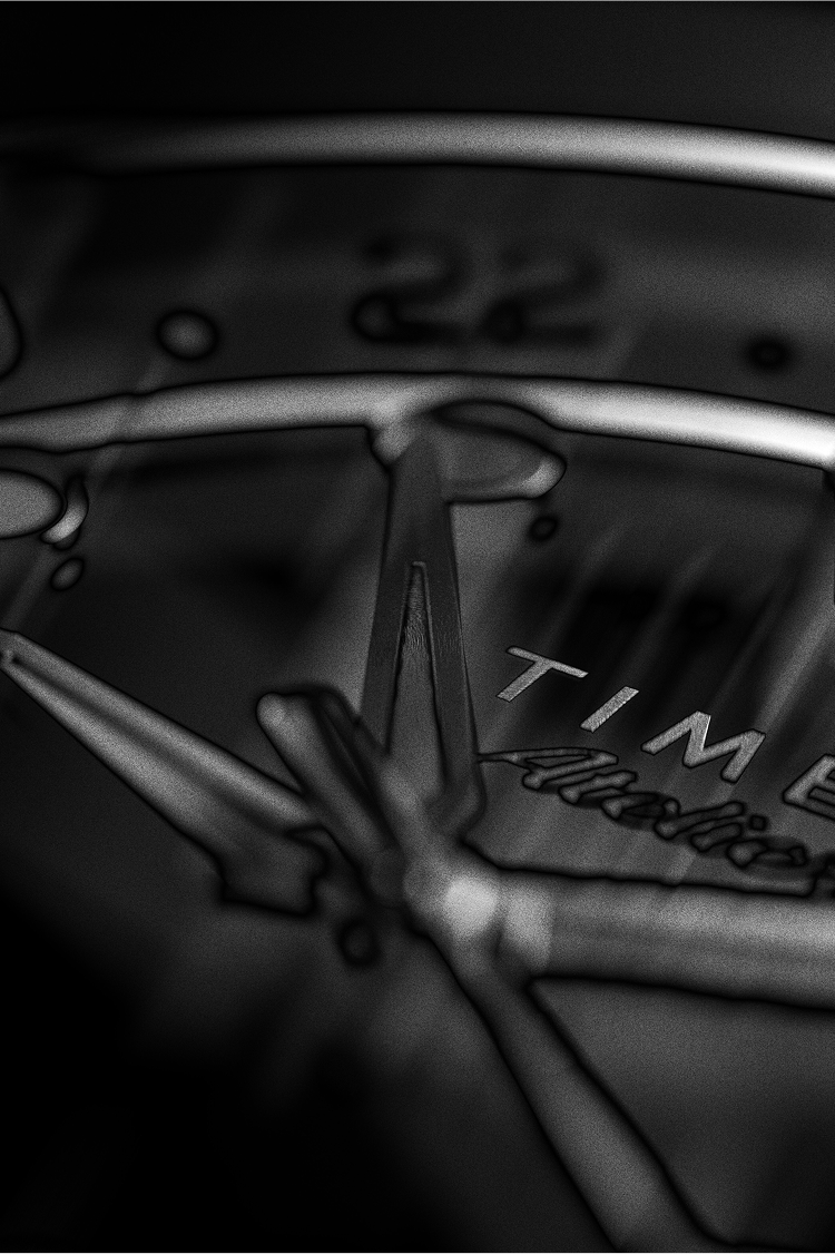 Extreme close-up of the Timex Atelier GMT dial in monochrome, focusing on polished hands, applied indices, and brand details.