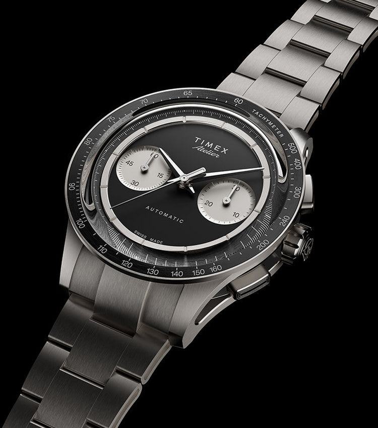 Timex Atelier Chronograph Automatic M1A Ti luxury watch featuring a brushed titanium bracelet, black dial, silver-tone chronograph subdials, tachymeter bezel, and Swiss-made automatic movement.