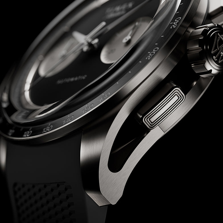Detailed view of the Timex Atelier Chronograph Automatic M1a Ti highlighting the skeletonized lug design, chronograph pusher, and brushed titanium case finish.
