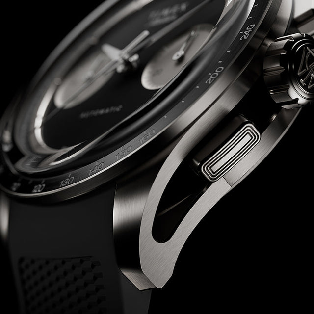 Detailed view of the Timex Atelier Chronograph Automatic M1a Ti highlighting the skeletonized lug design, chronograph pusher, and brushed titanium case finish.