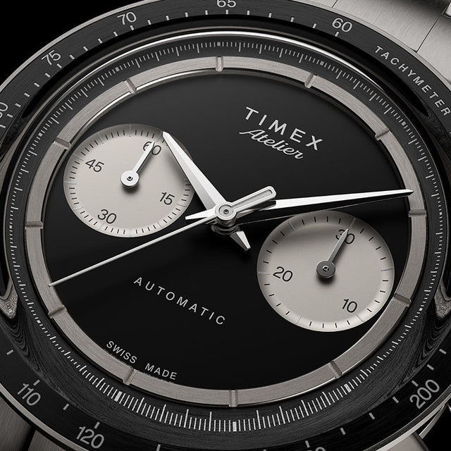 Close-up of Timex Atelier Chronograph Automatic Ti M1a black enamel dial with dual subdials and polished hands