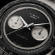 Close-up of Timex Atelier Chronograph Automatic Ti M1a black enamel dial with dual subdials and polished hands