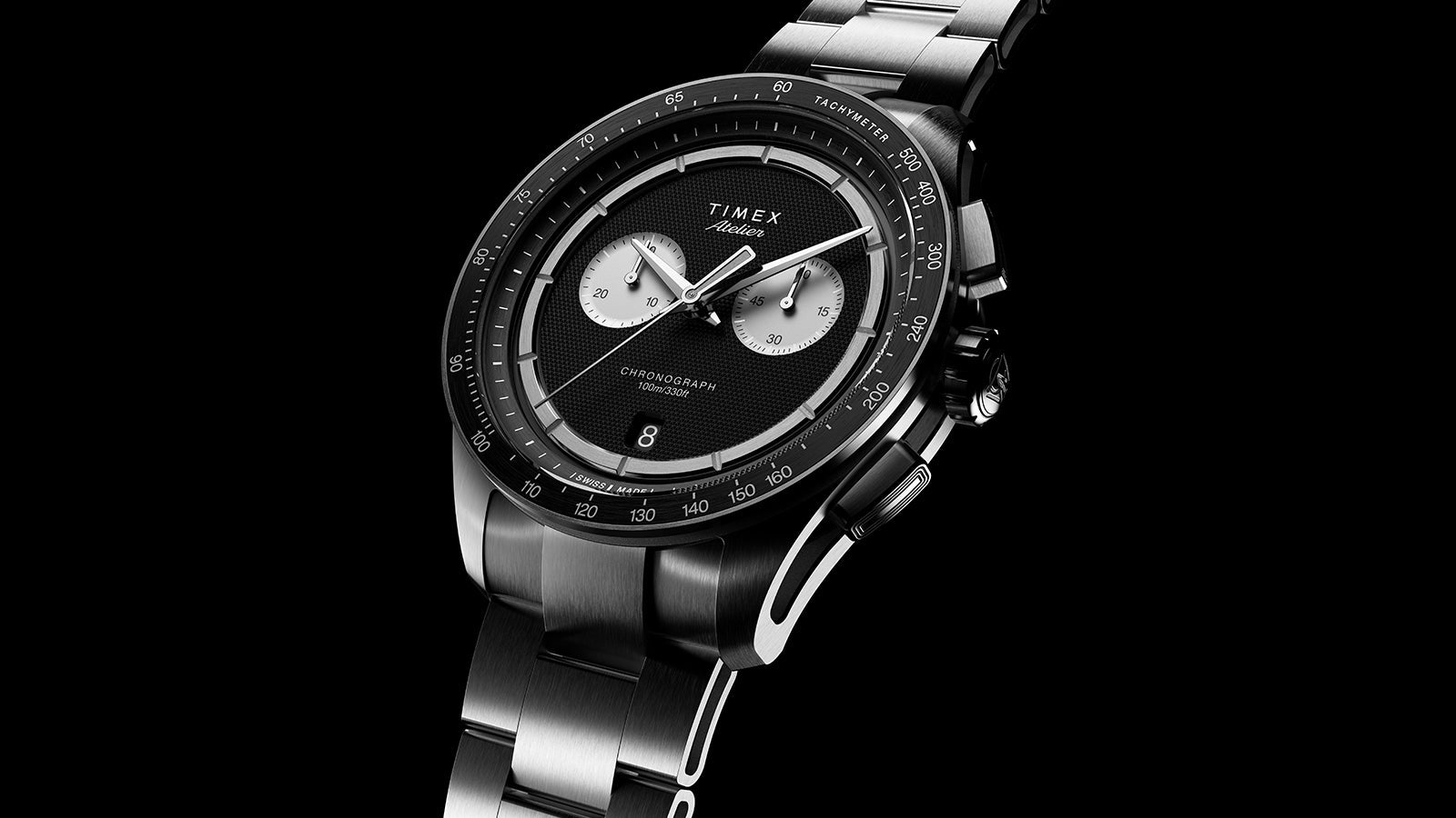 Angled view of Timex Atelier Chronograph Quartz M1a with black dial and stainless steel bracelet
