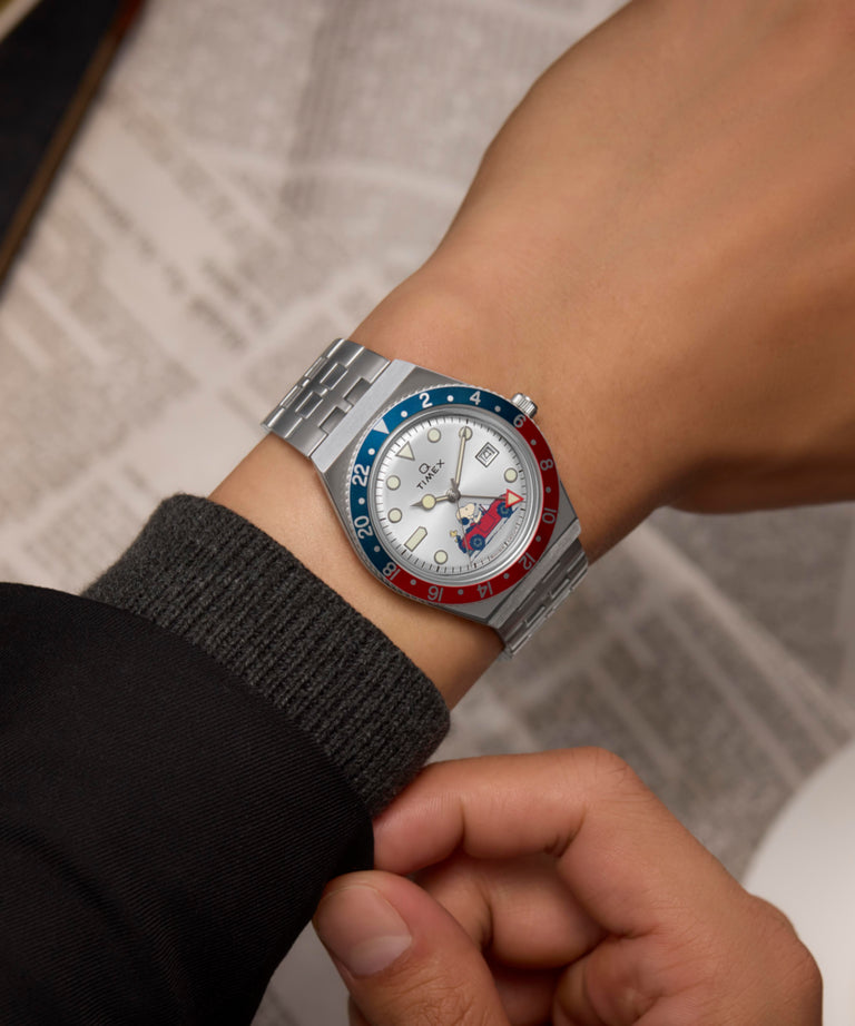 TW2W83300 Peanuts® x Q Timex® GMT 38mm Stainless Steel Bracelet Watch Alt Wrist Shot 1 Image