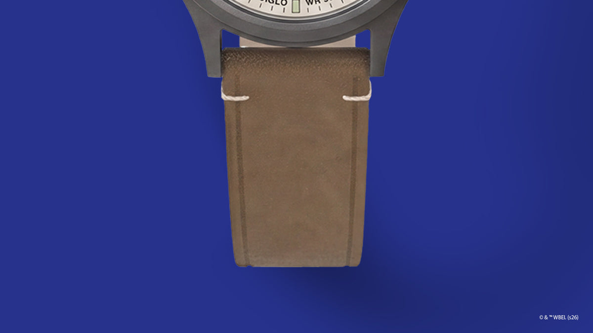 TW2Y99400 Close-up of the brown leather strap with cream stitching on the Road Runner & Wile E. Coyote x Timex Expedition® Scout watch.