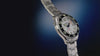 Rotating views of the Deepwater Meridian 200 HEV Automatic and its stainless-steel bracelet against a deep blue background.