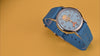 TW2Y99500 Rotating views of the Tweety Bird x Timex Weekender watch, highlighting its blue character dial, silver-tone case, and blue fabric strap against yellow and red backgrounds.