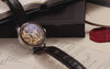 Harry Potter x Timex Waterbury Skeleton Automatic watch with black leather strap displayed on Hogwarts acceptance letters beside a red wax seal and open book, showcasing the intricate gold-tone skeleton dial.