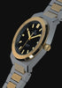 Timex Q Marbella two-tone stainless steel watch with a black textured dial, featuring rotating product views, close-up details of the gold-tone bezel and integrated bracelet, INDIGLO® illumination, and wrist shots highlighting its modern design.